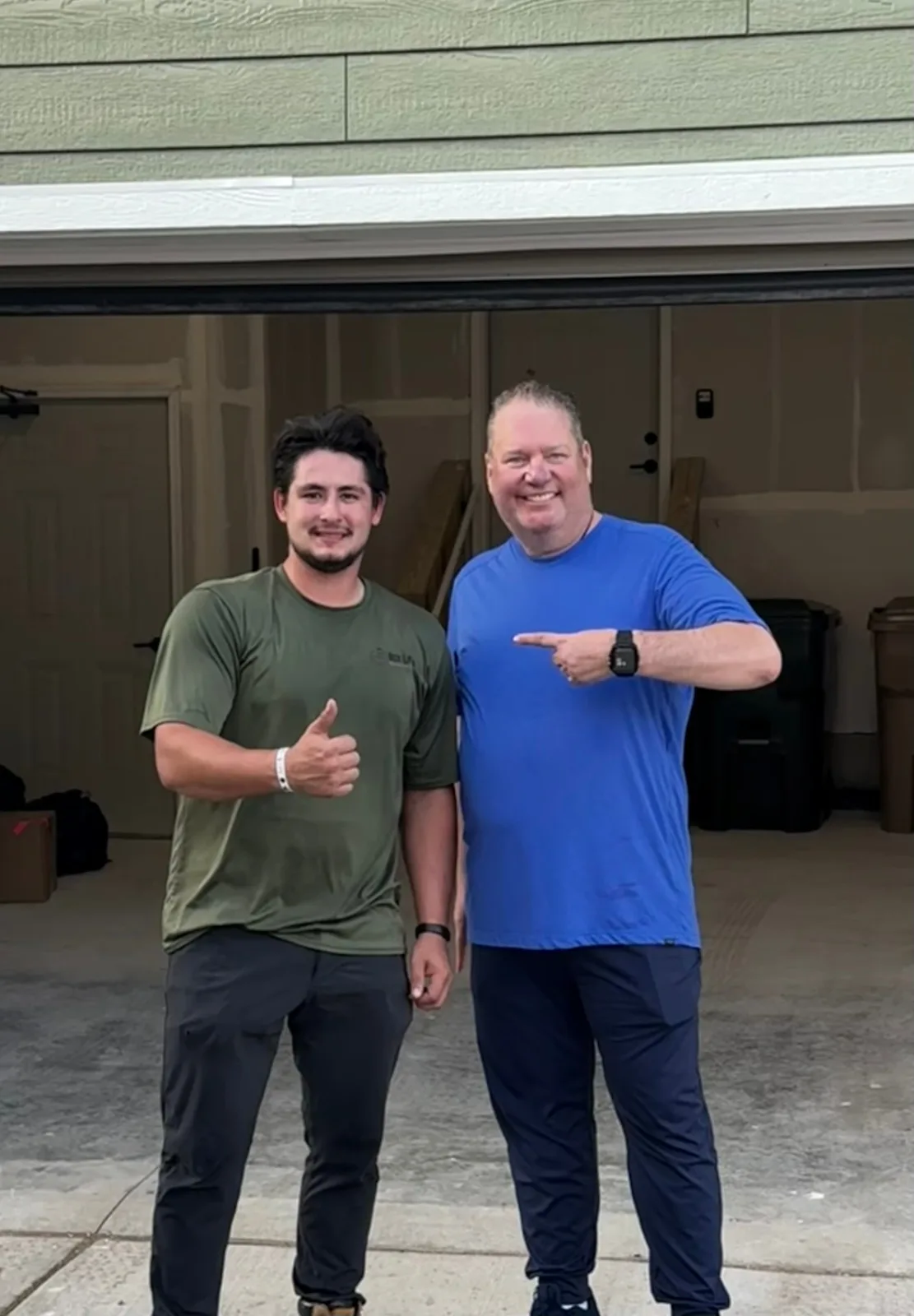Box Life Moving crew member giving a thumbs up with a happy customer pointing at him in his new garage