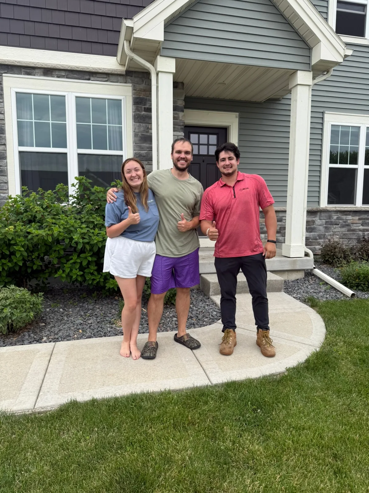 Box Life Moving crew with a happy Madison-area customer giving thumbs up in front of her new home