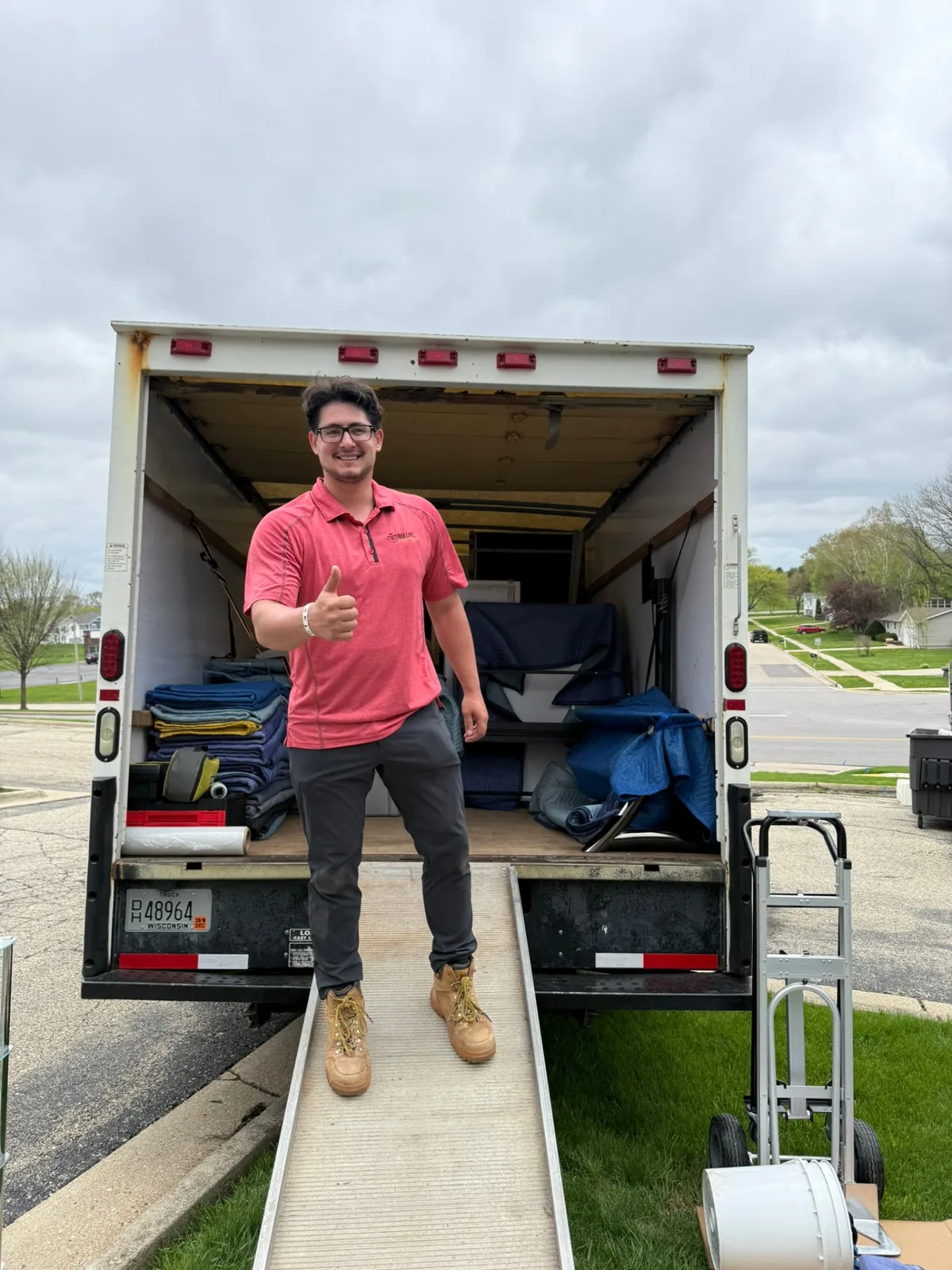 Jacob giving a thumbs up at the back of a loaded Box Life Moving truck