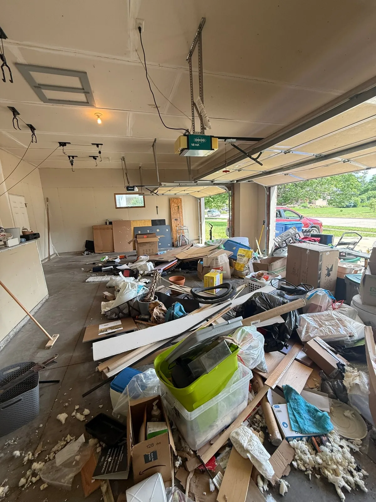 Before: cluttered Madison-area garage filled with boxes, debris, and old items prior to Box Life Moving cleanout