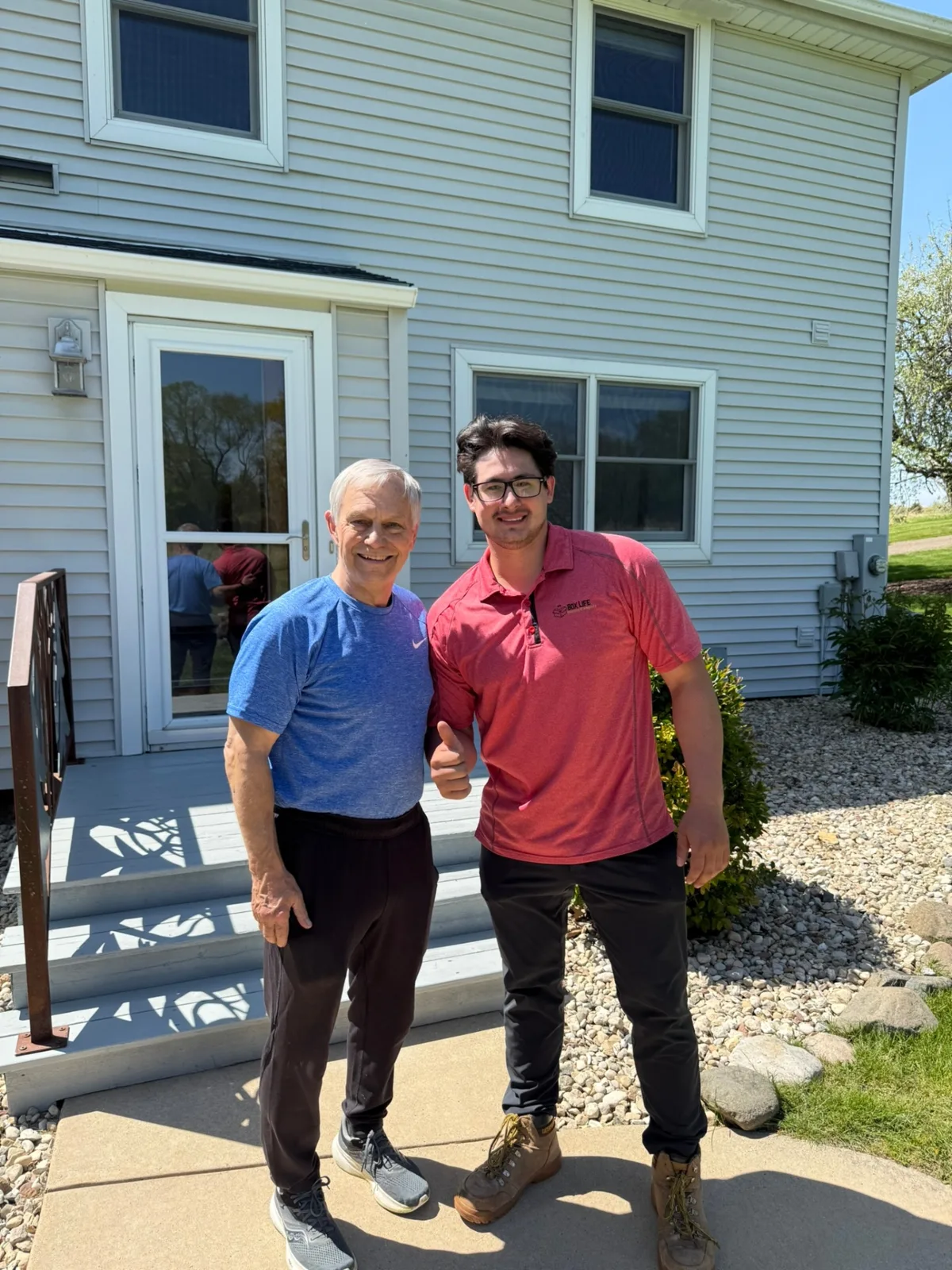 Happy Box Life Moving customer giving a thumbs up with Jacob after a successful move