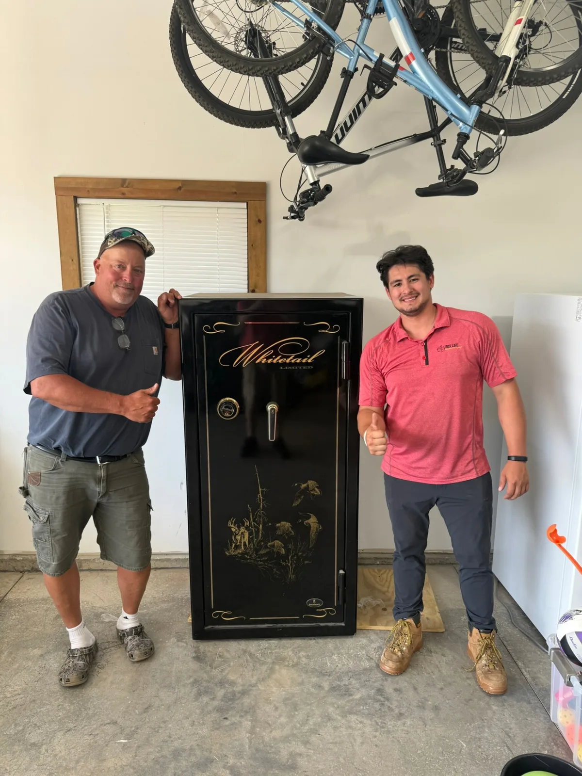 Box Life Moving crew with a customer after successfully moving a heavy Whitetail gun safe in a Wisconsin garage