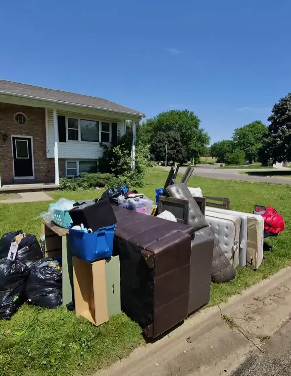Box Life Moving junk removal job with furniture, mattresses, and bagged items hauled to the curb